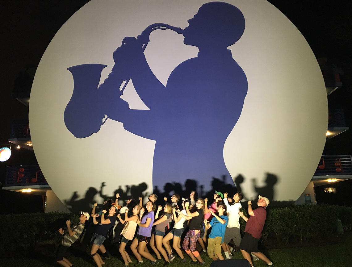 Teri Aitchison sharing a memory with Trojan Marching Band sax line at Disney's All Star Music Resort.