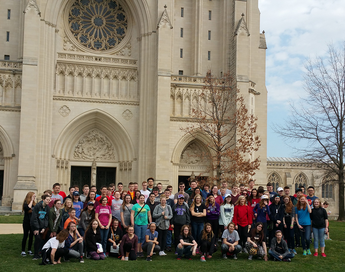Teri Aitchison sharing a memory with Bedord Middle School Band visiting the Washington Cathedral - constructed of Bedford limestone.
