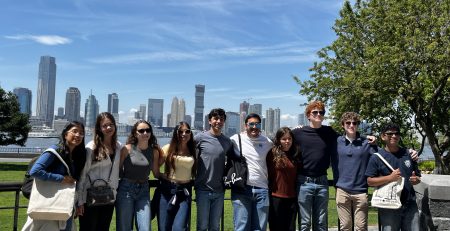 Students posing in front of the New York City skyline