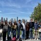 Students posing in front of the New York City skyline