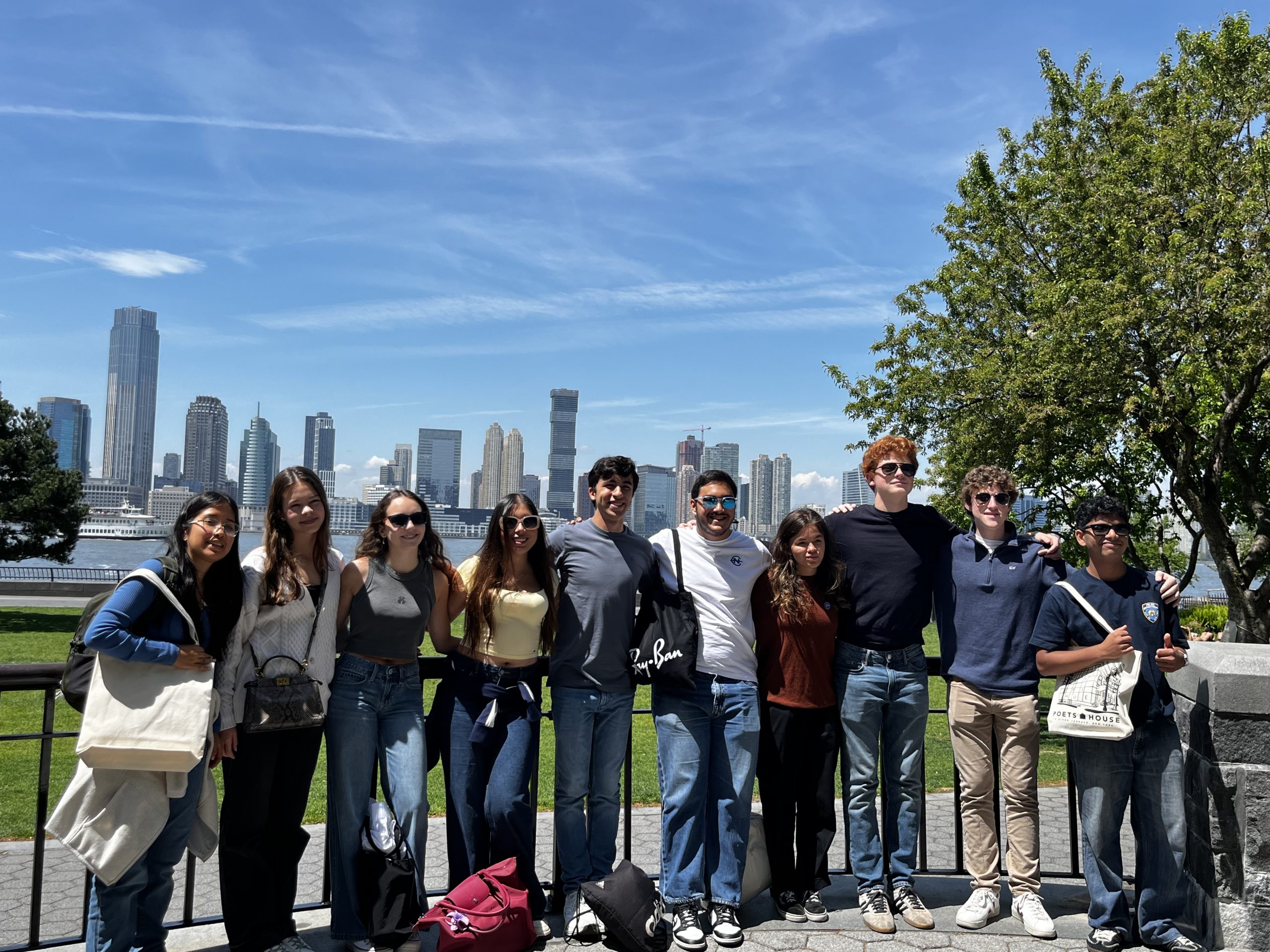 Students posing in front of the New York City skyline