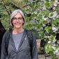 Jen Shenberger smiling under a blossoming tree