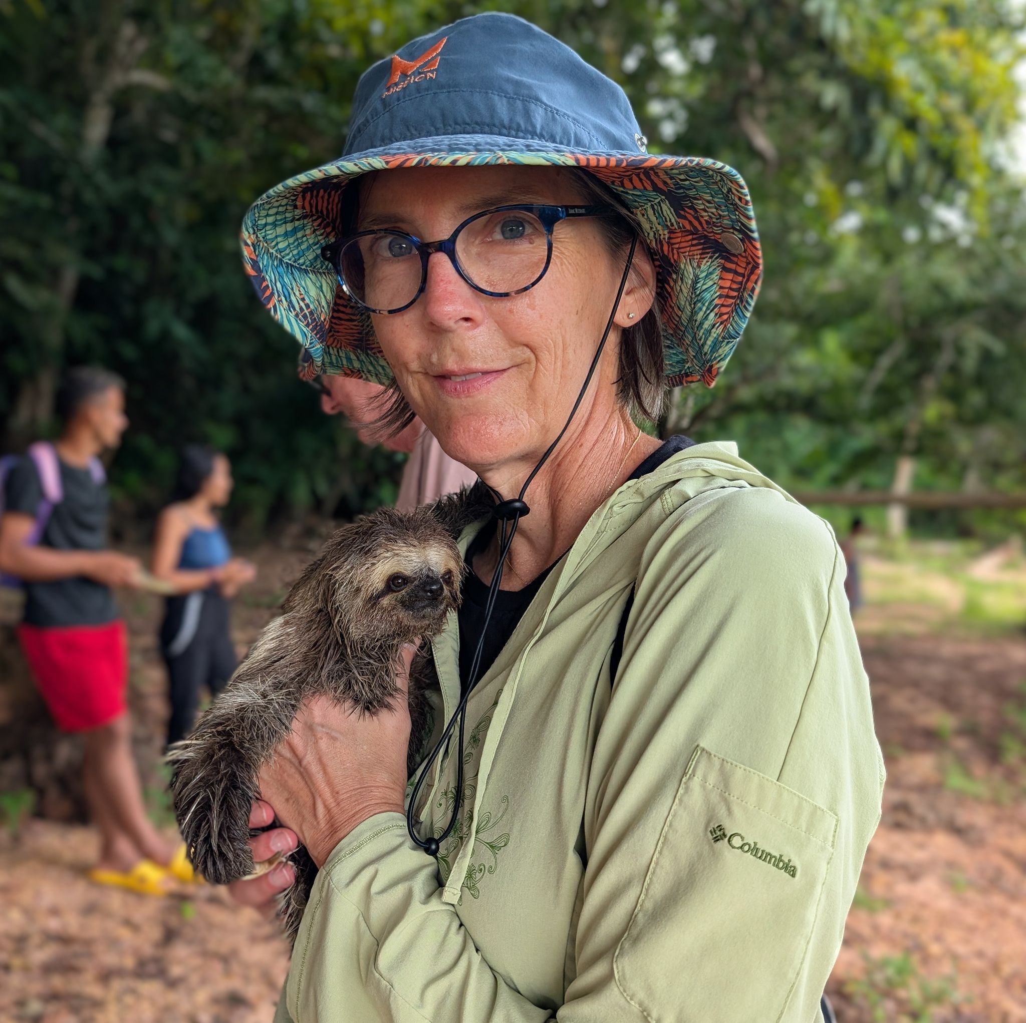 Jen Shenberger holding a sloth. both are smiling